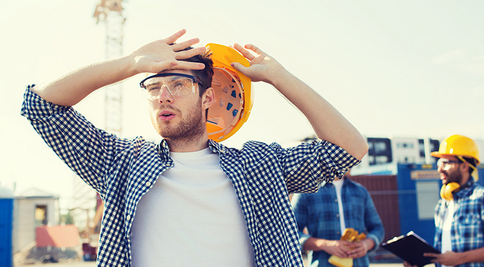 ICW Group's image of a construction worker wiping sweat from his brow.