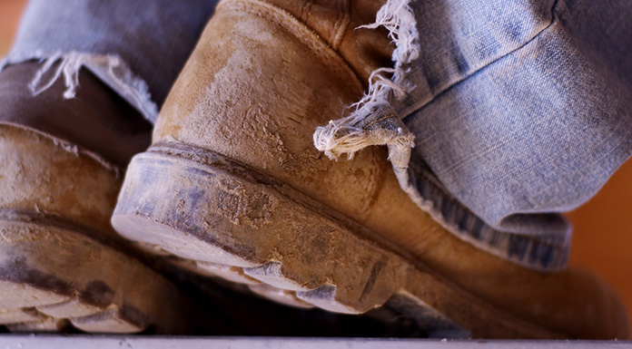 Work boots with mud on them.